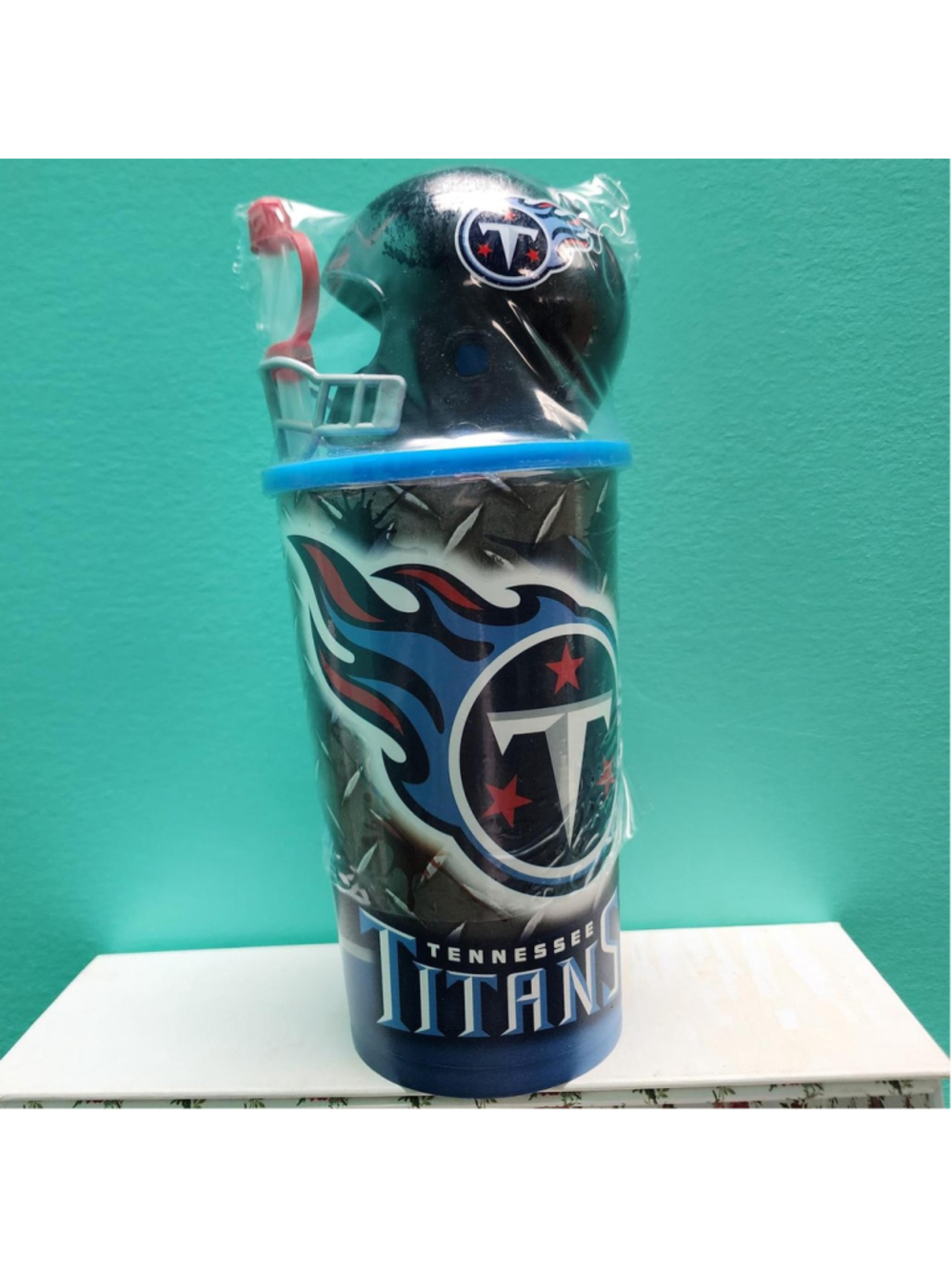 NFL Tennessee Titans water bottle with blue, red, and white flame design and tea